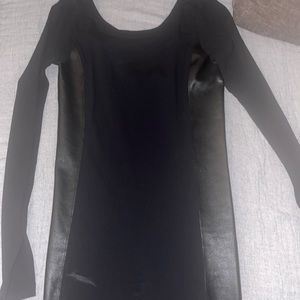 Super cute tight black dress with leather on the sides. Only wore once.